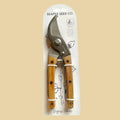 Garden pruners with wooden handles in packaging labeled 'Seattle Seed Co.'