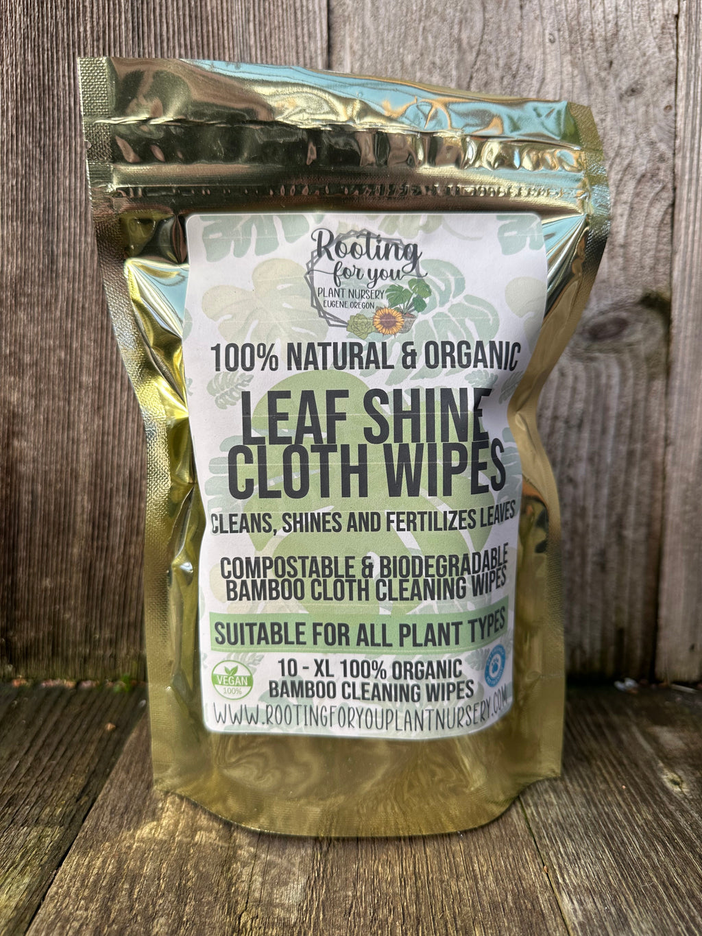 Pack of 100% natural and organic leaf shine cloth wipes on a wooden surface