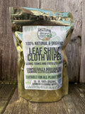 Pack of 100% natural and organic leaf shine cloth wipes on a wooden surface