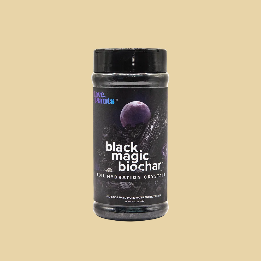 Jar of 'black magic biochar' soil hydration crystals on a plain 
background