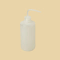 White plastic bottle with a pump dispenser on a white background